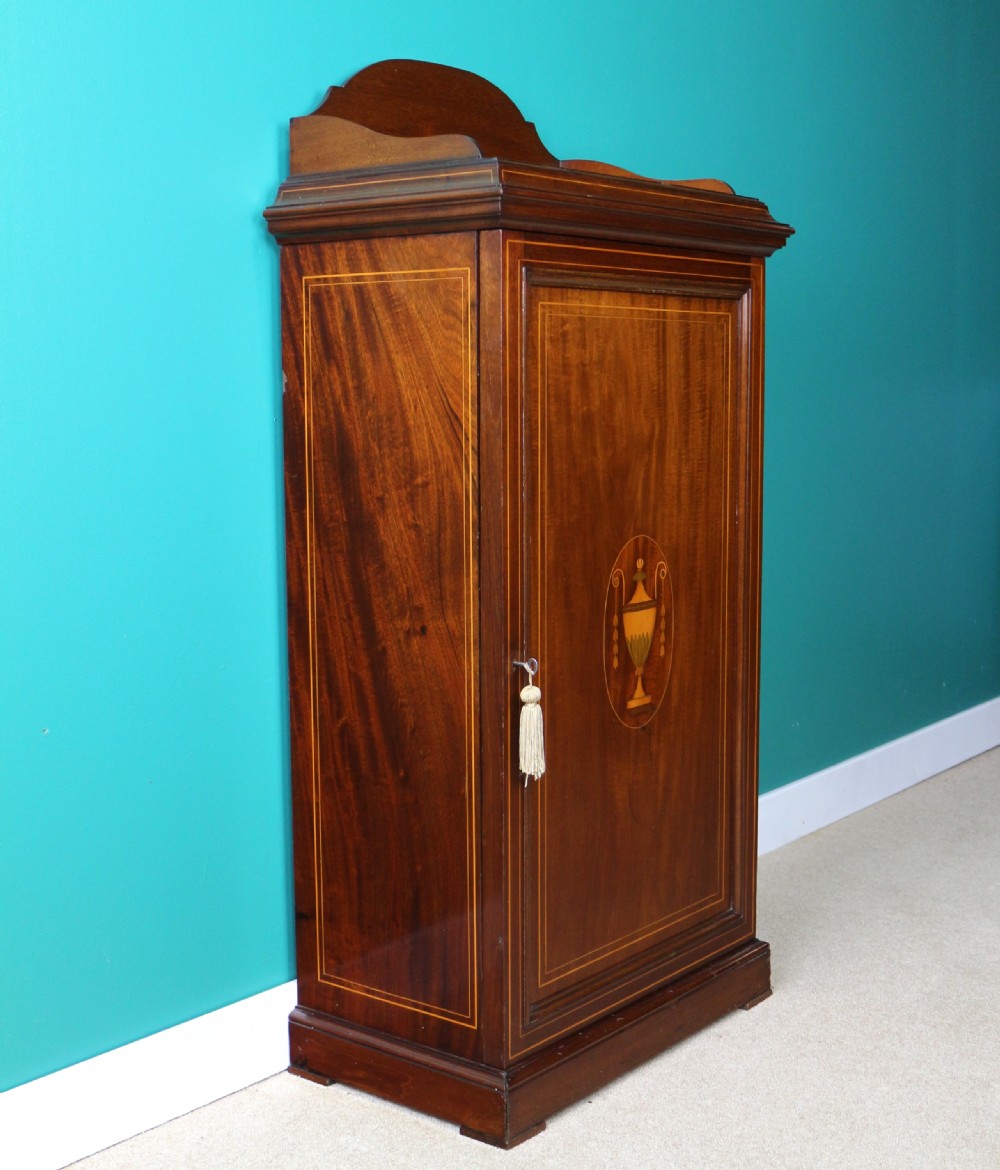 A Victorian mahogany music side cabinet featuring satinwood stringing, a central urn marquetry medallion on the door, and a shaped gallery top. View X