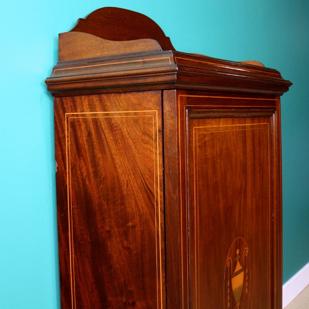 A Victorian mahogany music side cabinet featuring satinwood stringing, a central urn marquetry medallion on the door, and a shaped gallery top. View XI