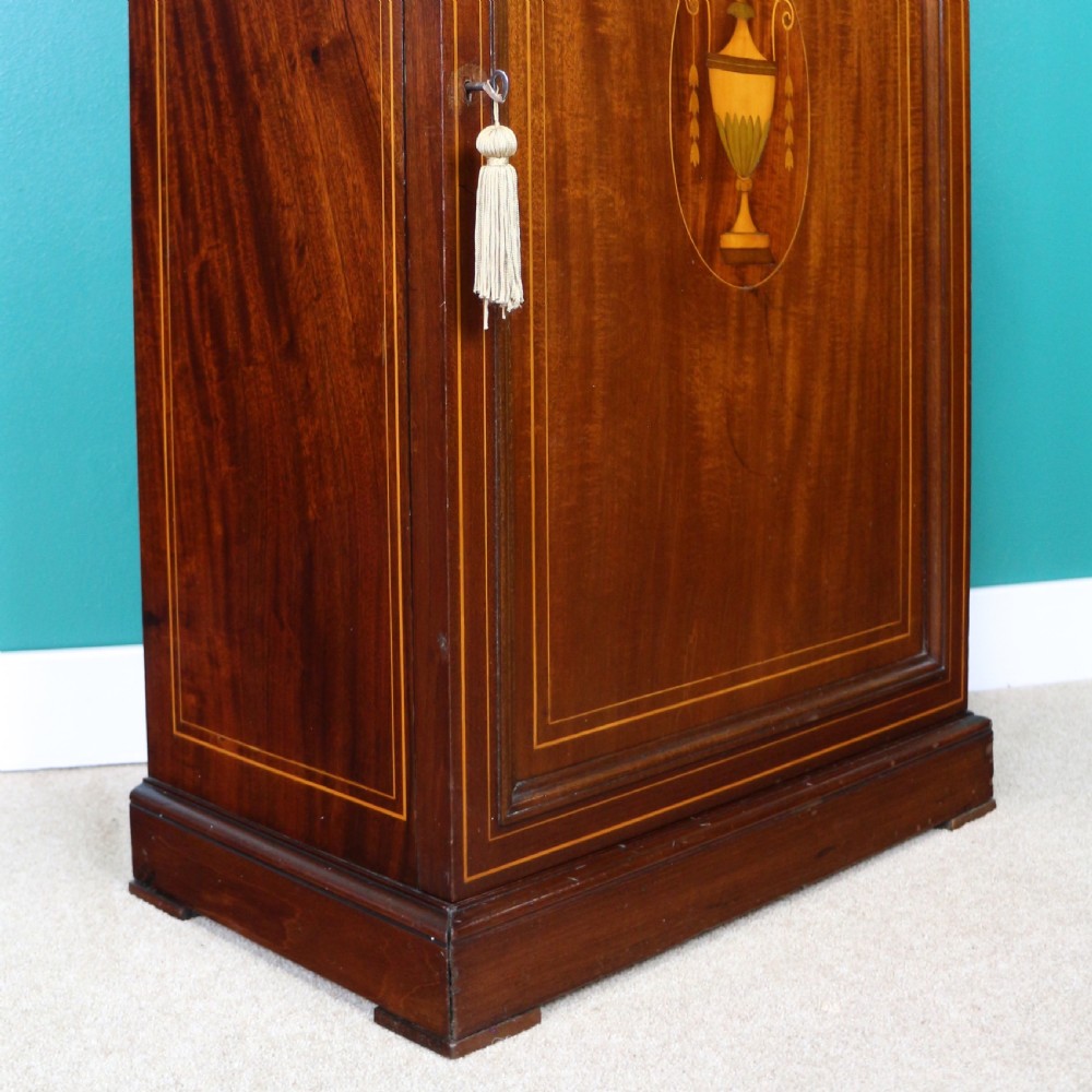 A Victorian mahogany music side cabinet featuring satinwood stringing, a central urn marquetry medallion on the door, and a shaped gallery top. View XII