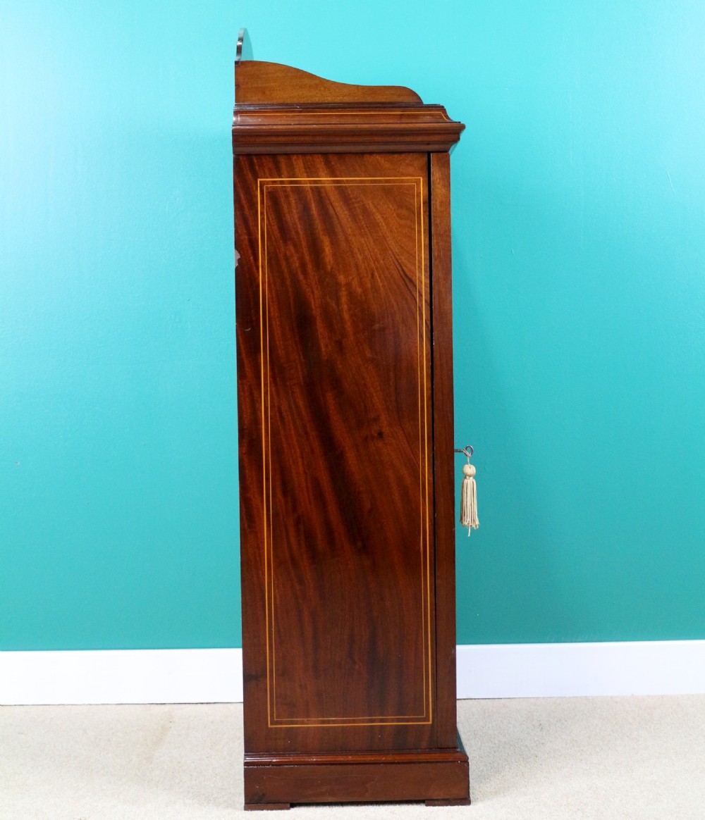 A Victorian mahogany music side cabinet featuring satinwood stringing, a central urn marquetry medallion on the door, and a shaped gallery top. View XIII