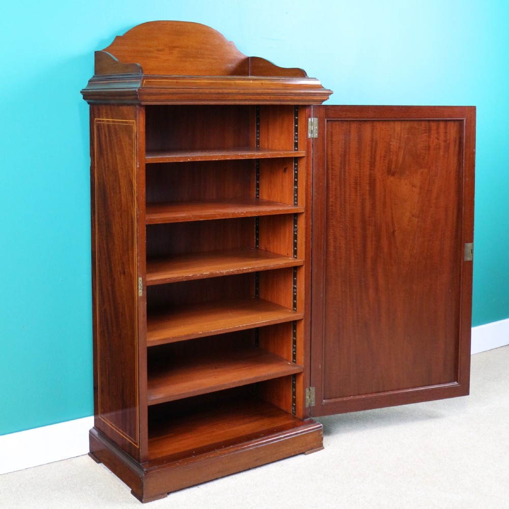 A Victorian mahogany music side cabinet featuring satinwood stringing, a central urn marquetry medallion on the door, and a shaped gallery top. View XVI