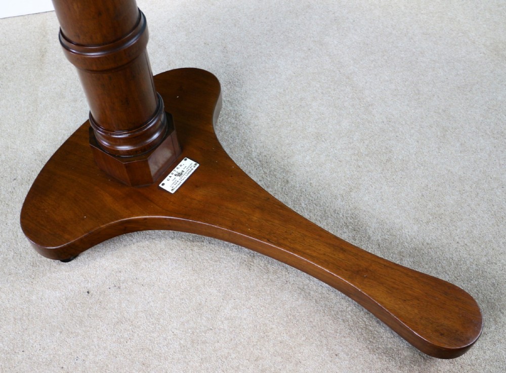 A Victorian mahogany adjustable reading table featuring a ratchet height mechanism, tilted top ledge, turned pedestal, and curved base on castors. View XIII