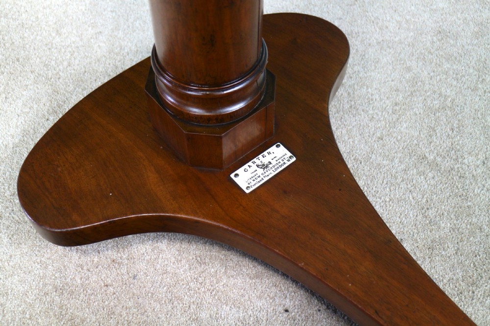A Victorian mahogany adjustable reading table featuring a ratchet height mechanism, tilted top ledge, turned pedestal, and curved base on castors. View XIV