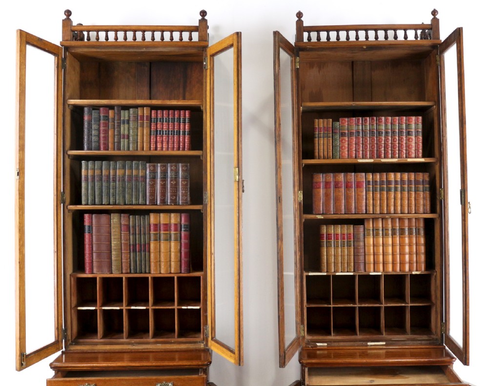 A pair of tall, narrow late Victorian oak glazed bookcases with spindle gallery tops and lower panelled cupboard bases. View XI