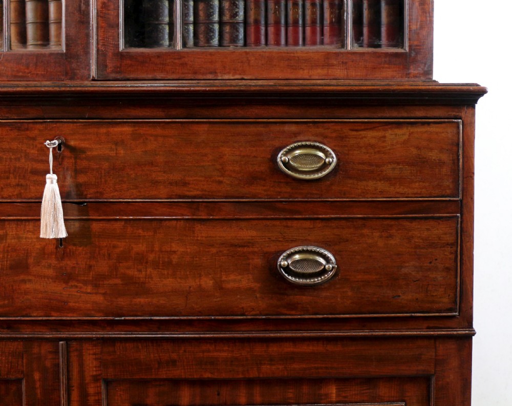 A George III mahogany secretaire bookcase featuring twin astragal glazed doors above a fitted writing drawer and lower panelled doors. View XI