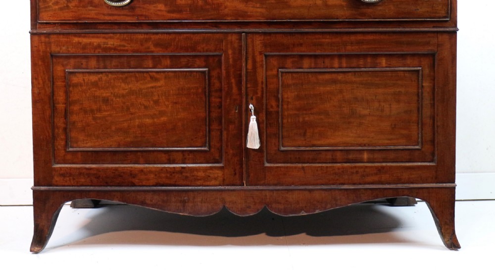 A George III mahogany secretaire bookcase featuring twin astragal glazed doors above a fitted writing drawer and lower panelled doors. View XII