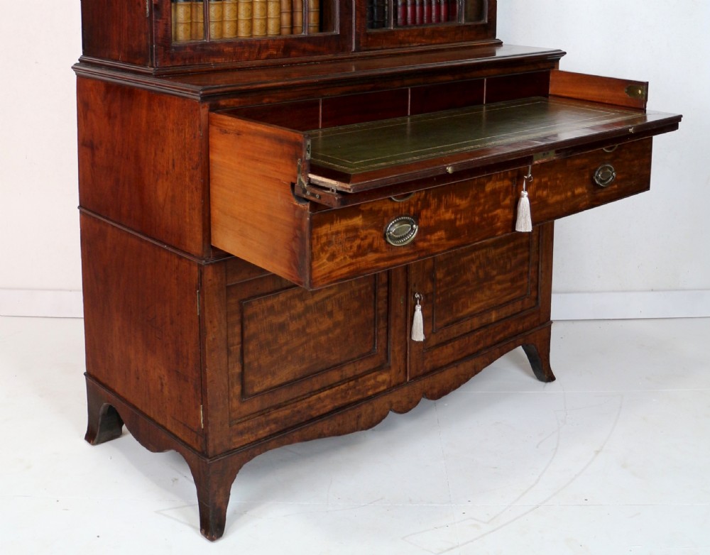 A George III mahogany secretaire bookcase featuring twin astragal glazed doors above a fitted writing drawer and lower panelled doors. View XV
