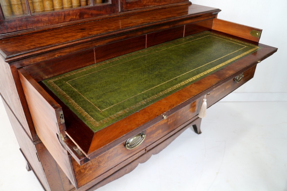 A George III mahogany secretaire bookcase featuring twin astragal glazed doors above a fitted writing drawer and lower panelled doors. View XVII