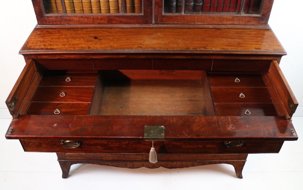 A George III mahogany secretaire bookcase featuring twin astragal glazed doors above a fitted writing drawer and lower panelled doors. View XXI