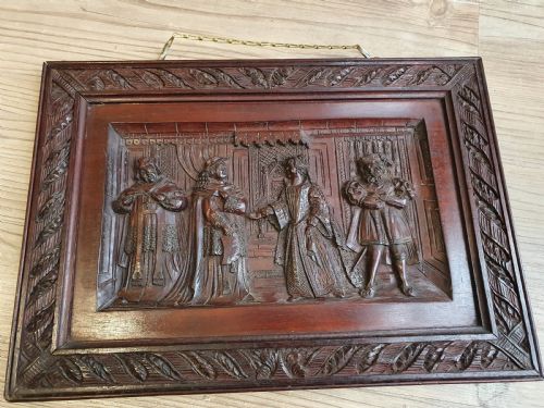 A Victorian Mahogany Carved Relief Panel Depicting Tudor Interior Scene