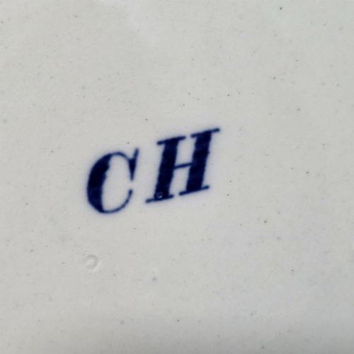 fig 4. A cylindrical blue and white transferware ceramic tankard featuring a floral upper border and a coat of arms crest with the text No 11.