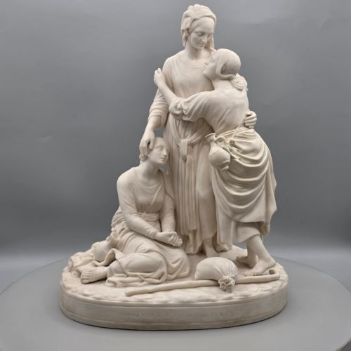 fig 2. A Victorian off-white parian porcelain figural group depicting three women in classical draped robes on an oval base.