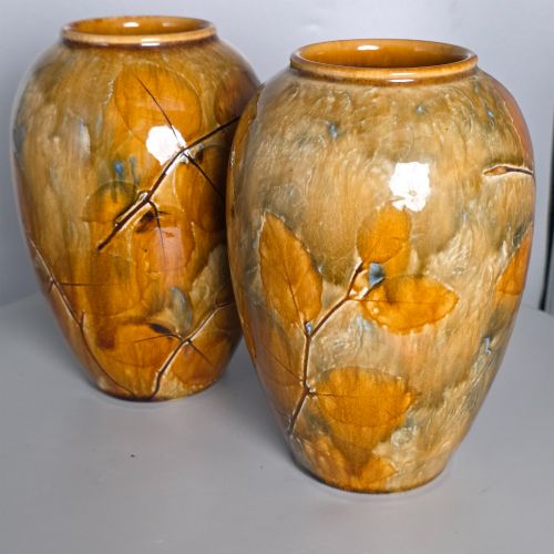 fig 1. A pair of Edwardian baluster-shaped stoneware vases with warm ochre glaze and impressed leaf motifs.
