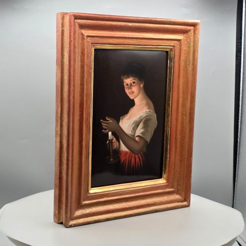 fig 3. A nineteenth-century framed hand-painted KPM porcelain plaque featuring a young woman holding a lit candle against a dark background.