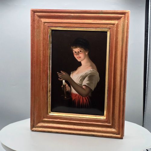 fig 4. A nineteenth-century framed hand-painted KPM porcelain plaque featuring a young woman holding a lit candle against a dark background.