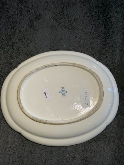 fig 1. An oval French Sevres porcelain dish featuring a deep cobalt blue rim decorated with intricate gold leaf gilding surrounding a central hand-painted maritime harbour scene.