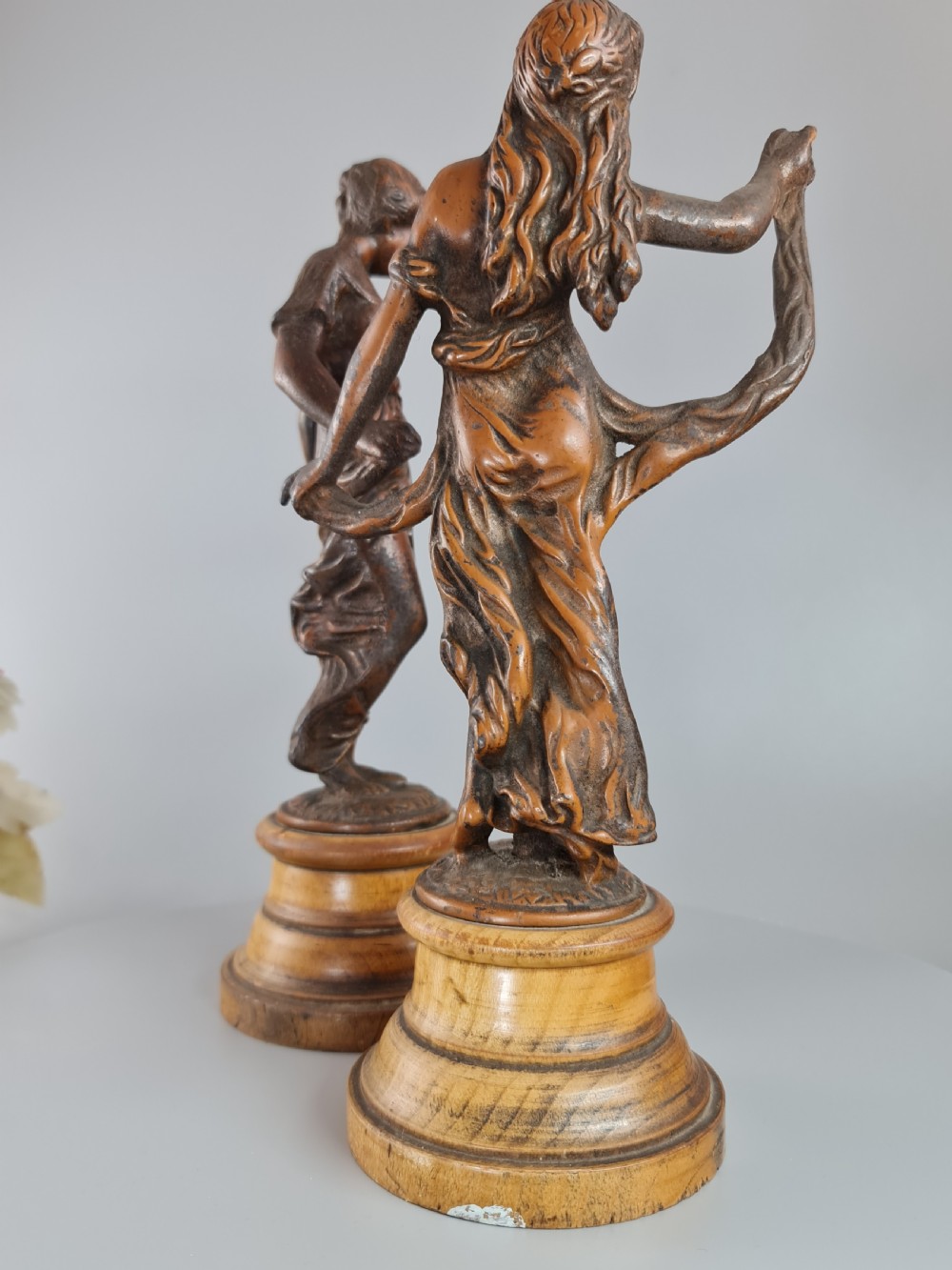 PAIR OF NEOCLASSICAL STYLE SPELTER FIGURES OF 'MODESTY' AND 'GAIETY' on wooden plinths c1900 View II