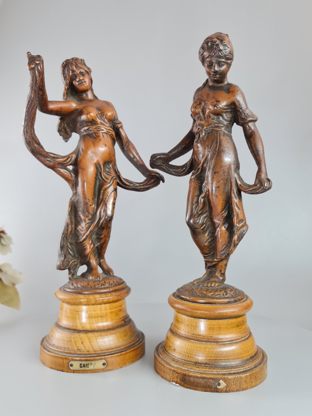 PAIR OF NEOCLASSICAL STYLE SPELTER FIGURES OF 'MODESTY' AND 'GAIETY' on wooden plinths c1900 View V