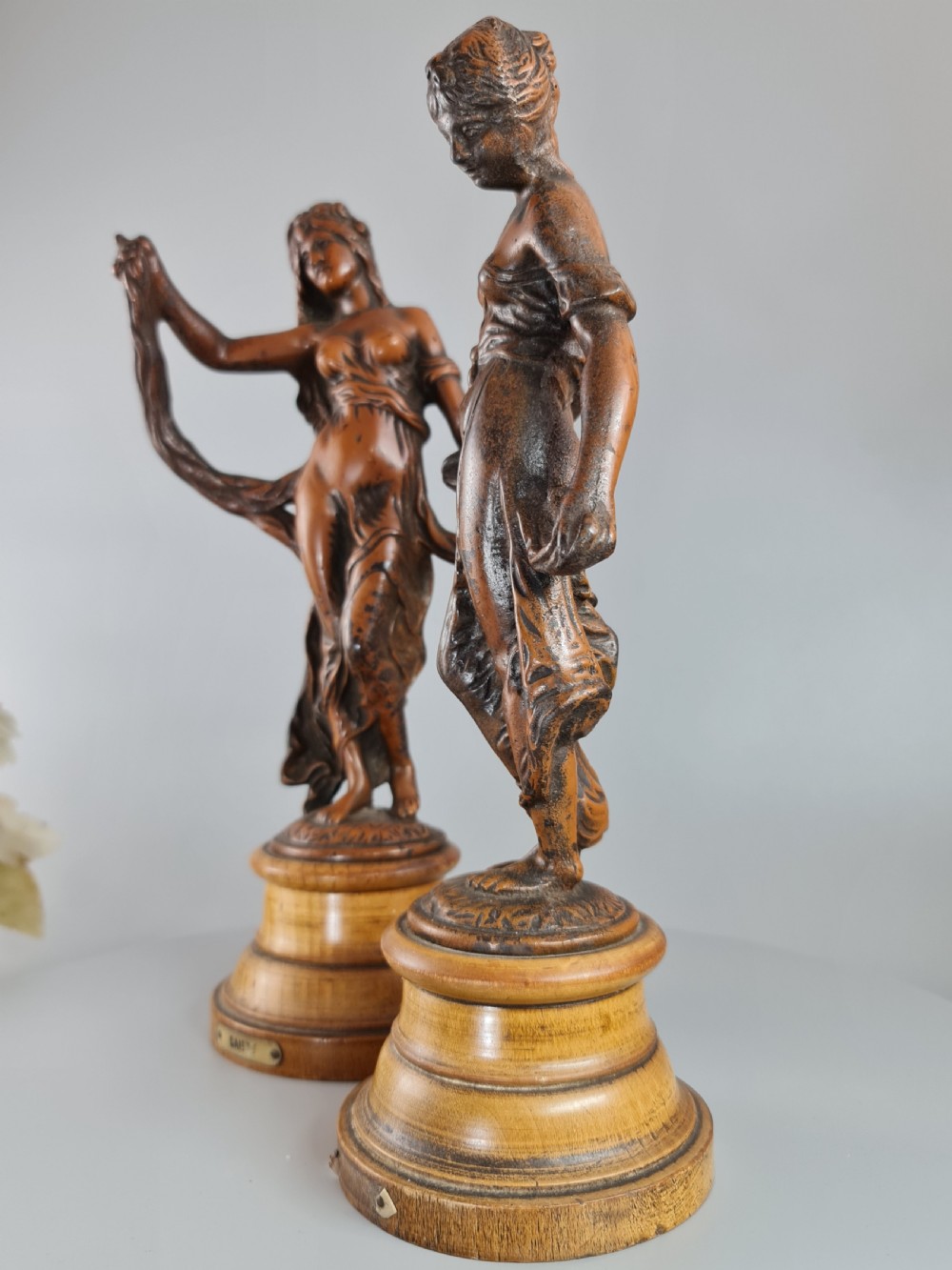 PAIR OF NEOCLASSICAL STYLE SPELTER FIGURES OF 'MODESTY' AND 'GAIETY' on wooden plinths c1900 View VI