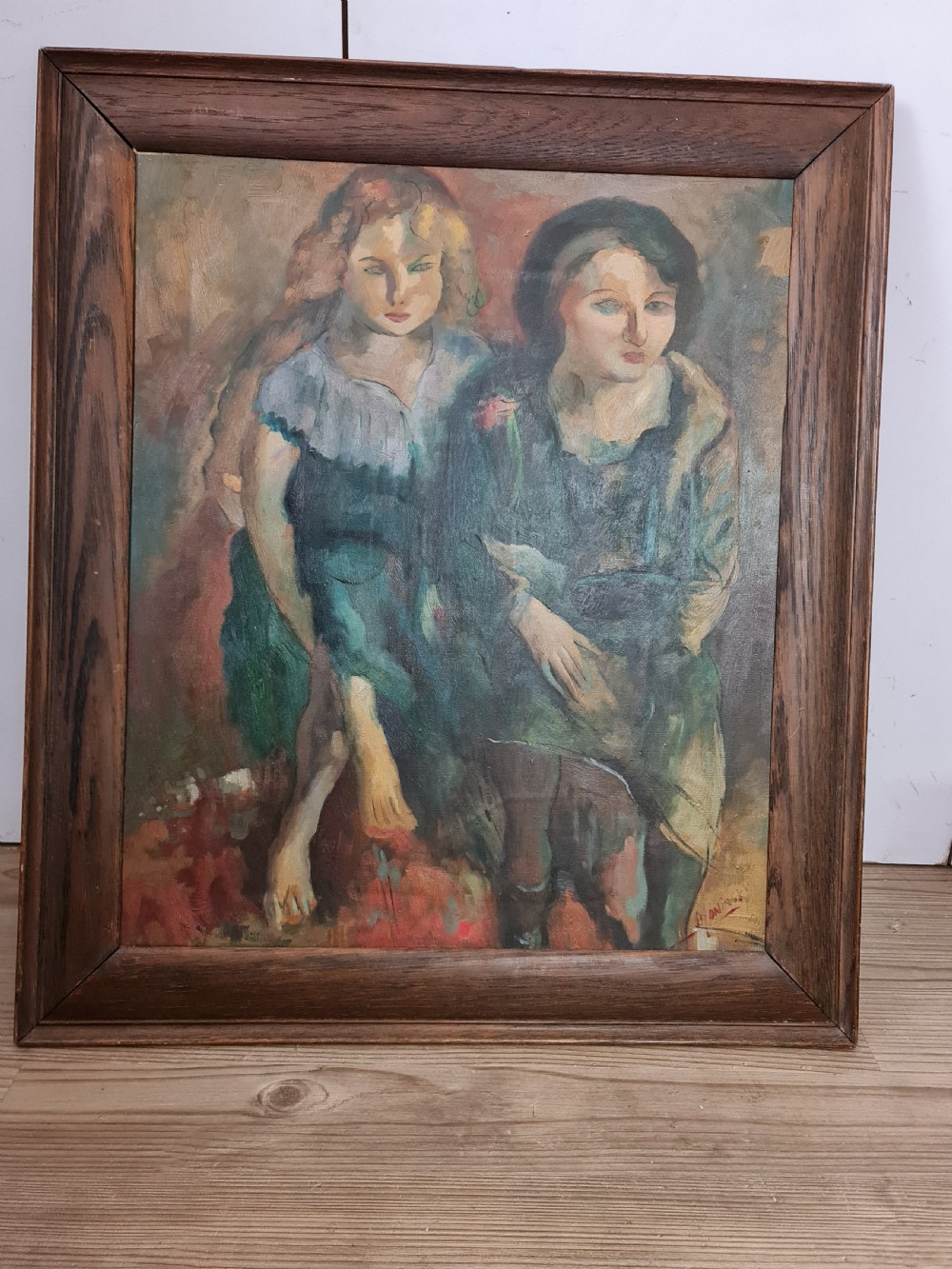 A mid-20th-century figurative oil painting depicting two female figures rendered in muted green, ochre, and brown tones, encased within a dark oak frame.