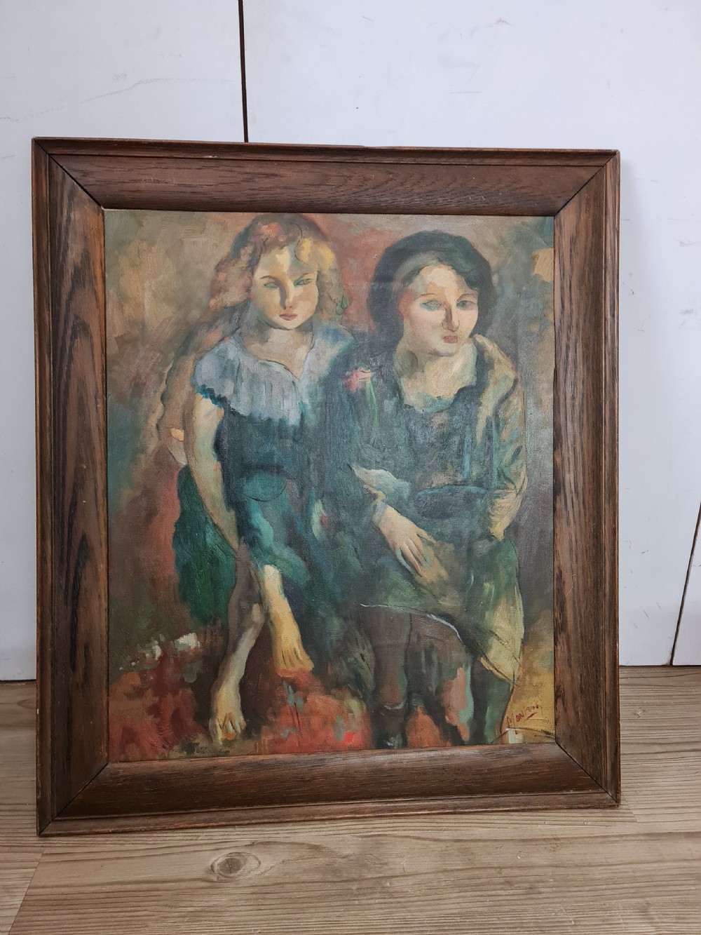 A mid-20th-century figurative oil painting depicting two female figures rendered in muted green, ochre, and brown tones, encased within a dark oak frame. View II