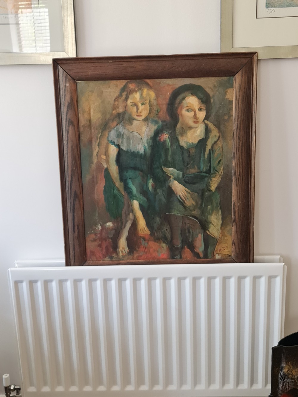 A mid-20th-century figurative oil painting depicting two female figures rendered in muted green, ochre, and brown tones, encased within a dark oak frame. View III