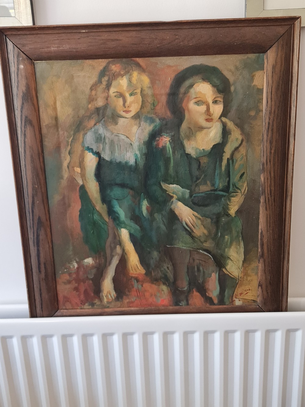 A mid-20th-century figurative oil painting depicting two female figures rendered in muted green, ochre, and brown tones, encased within a dark oak frame. View VI