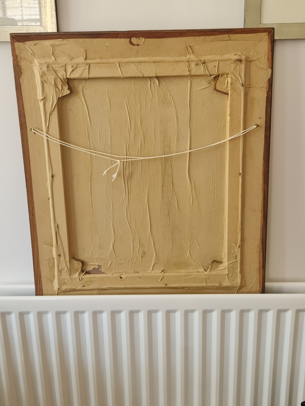 A mid-20th-century figurative oil painting depicting two female figures rendered in muted green, ochre, and brown tones, encased within a dark oak frame. View X
