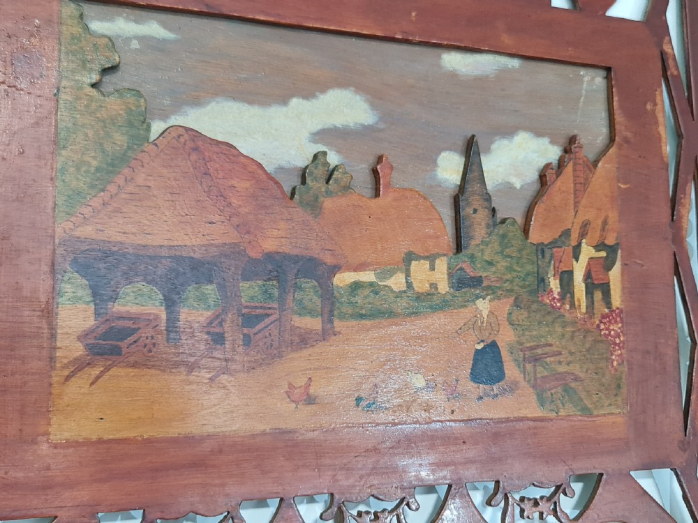 A pair of framed three-dimensional wooden folk art pictures featuring rural village scenes set within fretted reddish-brown frames. View XI