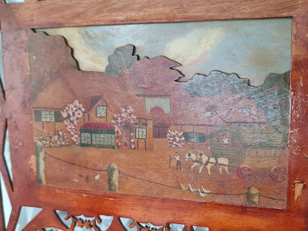 A pair of framed three-dimensional wooden folk art pictures featuring rural village scenes set within fretted reddish-brown frames. View XIII