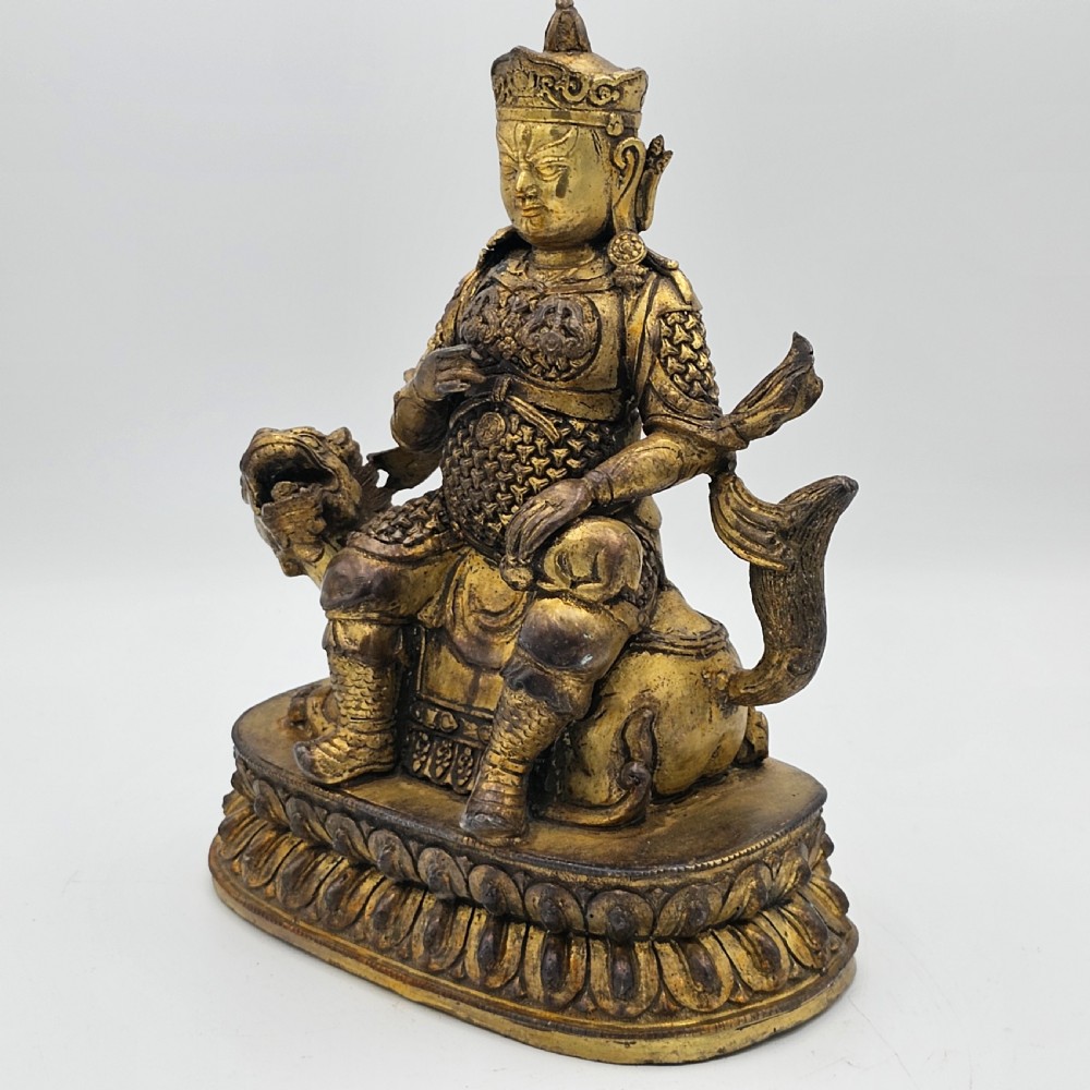 Antique Sino Tibetan Gilt Bronze Deity Astride a Kylin View II