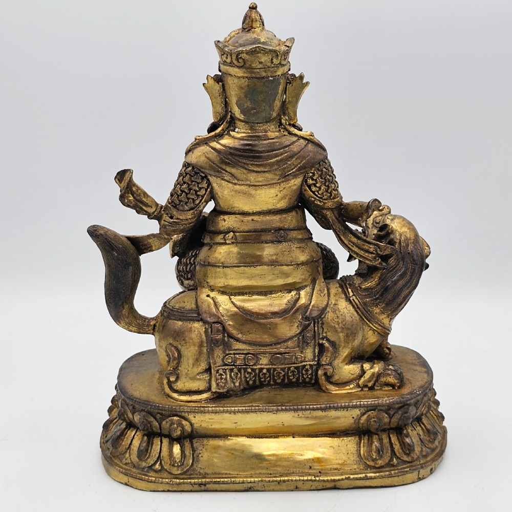 Antique Sino Tibetan Gilt Bronze Deity Astride a Kylin View III