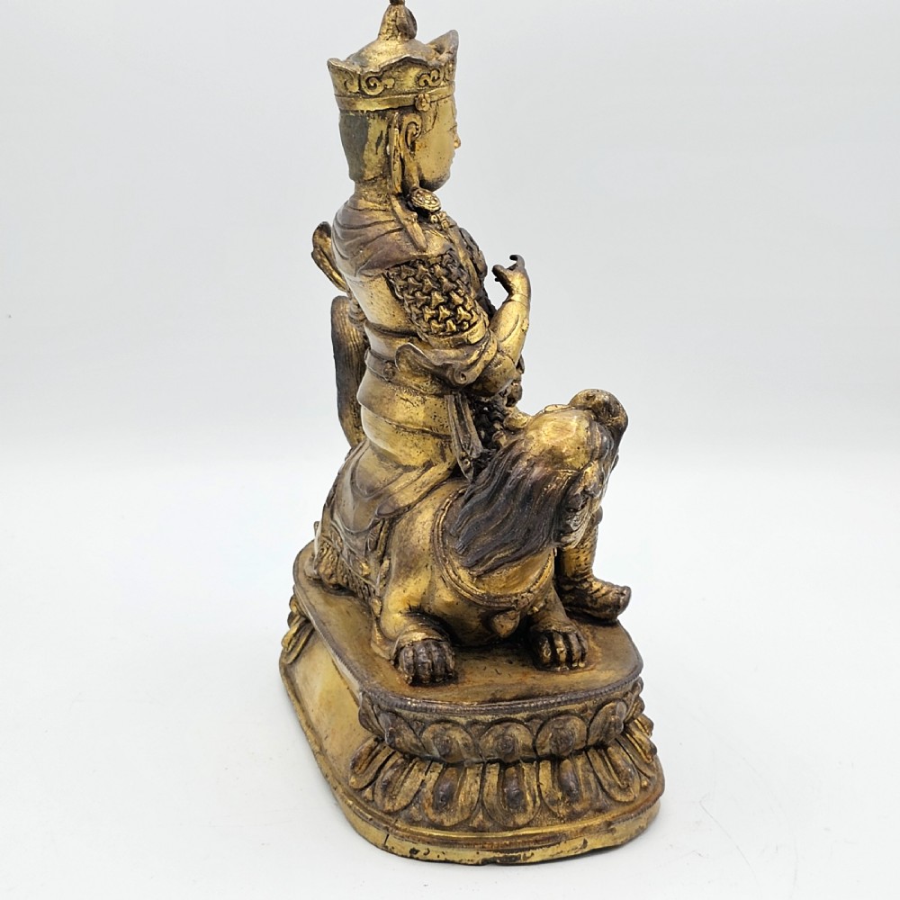 Antique Sino Tibetan Gilt Bronze Deity Astride a Kylin View VII