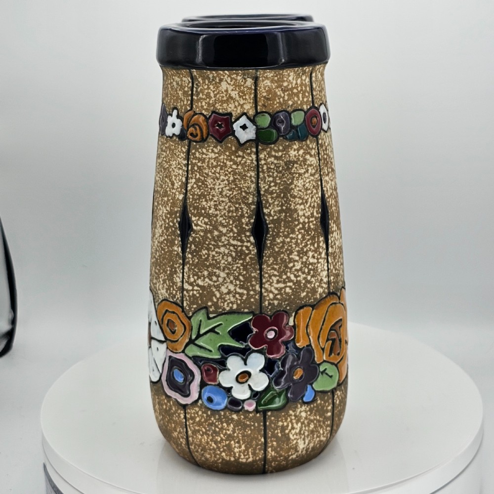 A pair of cylindrical Austrian ceramic vases featuring a textured beige ground, black rim, vertical cutouts, and colourful enamelled floral bands. View XV