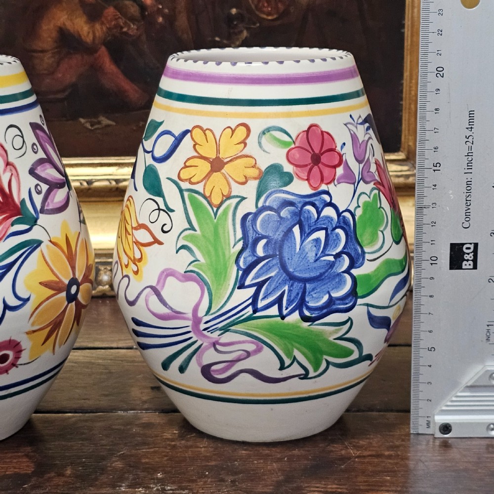 A pair of ovoid off-white ceramic vases decorated with hand-painted floral motifs in pink, purple, blue, green, and yellow. View VIII