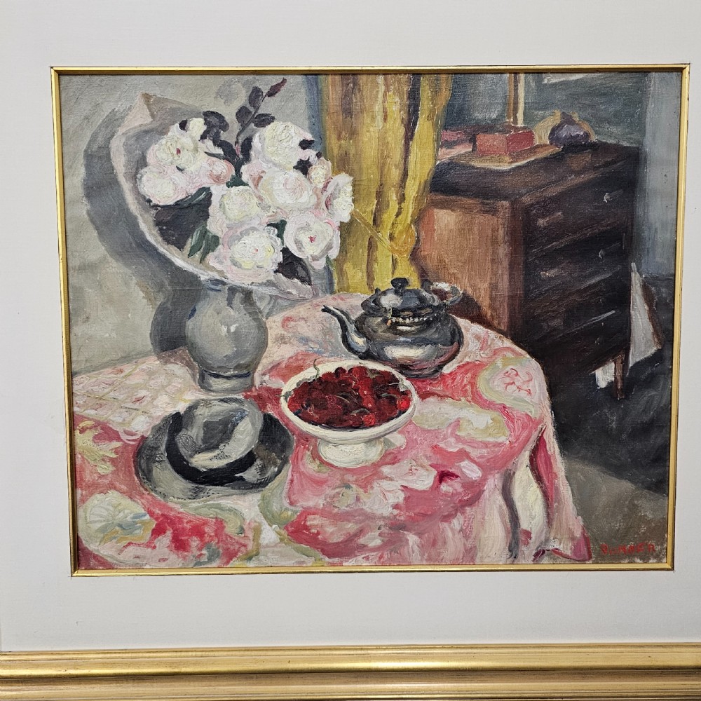 A framed oil painting depicting a detailed still life scene with a vase of white flowers, a teapot, a bowl of cherries, and a hat on a pink patterned tablecloth. View II