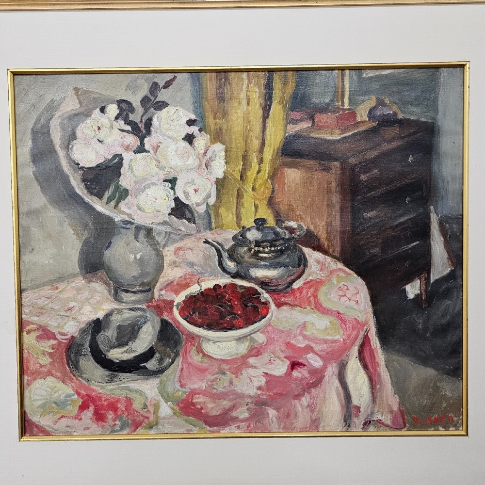 A framed oil painting depicting a detailed still life scene with a vase of white flowers, a teapot, a bowl of cherries, and a hat on a pink patterned tablecloth. View III