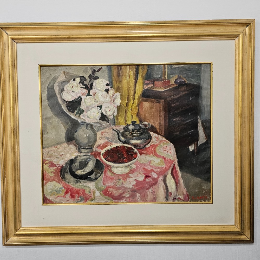 A framed oil painting depicting a detailed still life scene with a vase of white flowers, a teapot, a bowl of cherries, and a hat on a pink patterned tablecloth. View VII