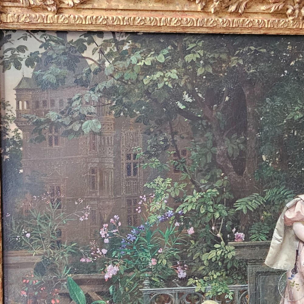 An 1880 framed oil painting depicting a woman in a pink dress beside a garden fountain with birds, presented in a heavily carved gilded frame. View V