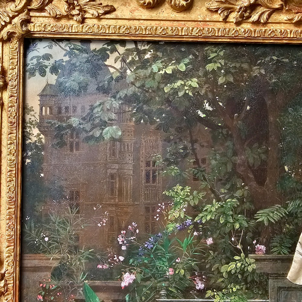 An 1880 framed oil painting depicting a woman in a pink dress beside a garden fountain with birds, presented in a heavily carved gilded frame. View IX