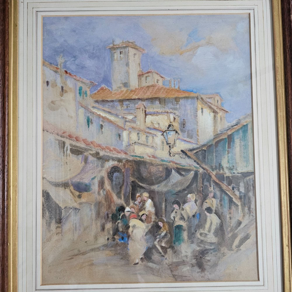 A framed Victorian watercolour painting depicting a European town market square with figures, architectural details, and a central tower in soft earth tones. View III