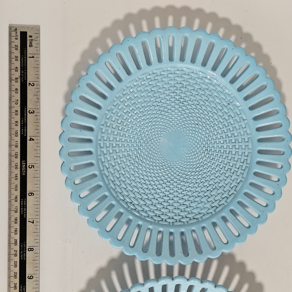 A pair of round pale blue opaque pressed glass dishes featuring openwork fretted rims and an embossed basketweave pattern in the centre. View V