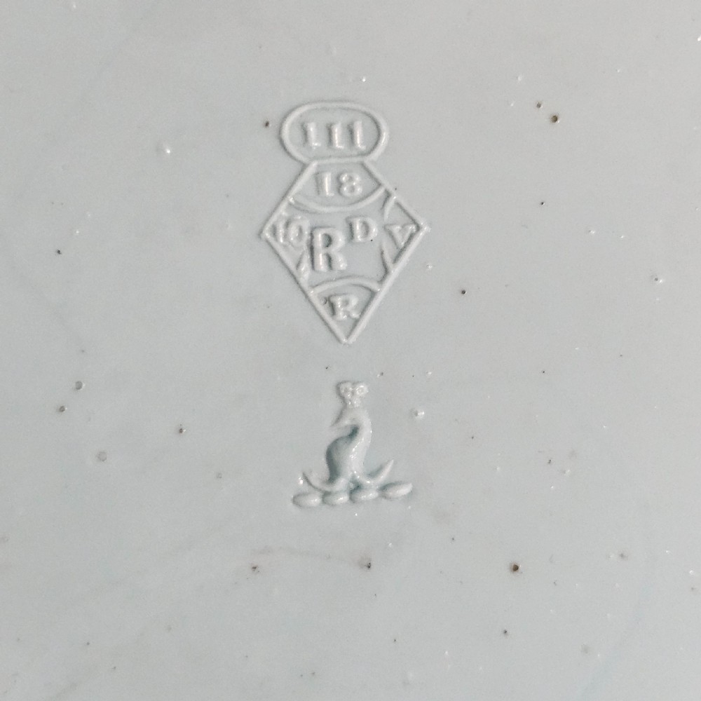 A pair of round pale blue opaque pressed glass dishes featuring openwork fretted rims and an embossed basketweave pattern in the centre. View VIII
