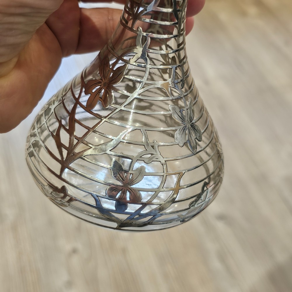 An early 20th-century glass decanter featuring an intricate sterling silver floral overlay and matching stopper. View VII