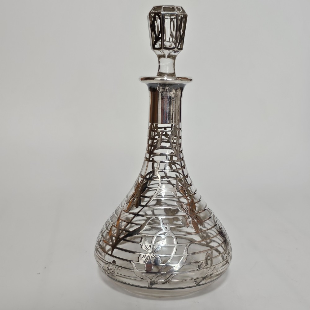 An early 20th-century glass decanter featuring an intricate sterling silver floral overlay and matching stopper. View XIII