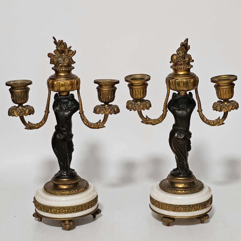 A pair of French Louis XVI-style marble and ormolu two-light candelabra, 20th Century.