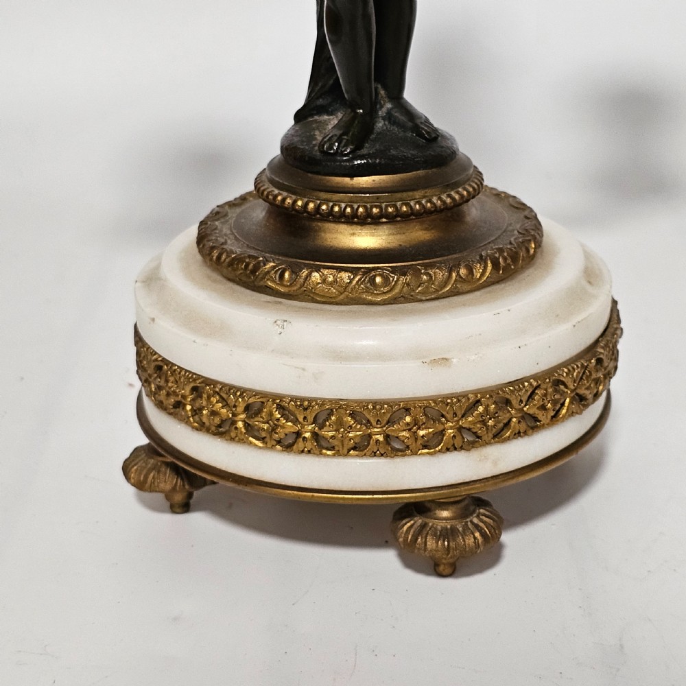 A pair of French Louis XVI-style marble and ormolu two-light candelabra, 20th Century. View XVI