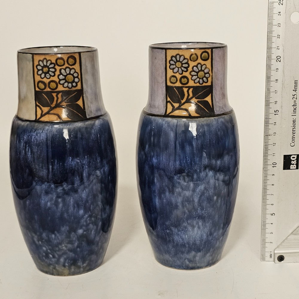 A pair of Royal Doulton stoneware vases featuring mottled blue glaze bodies and upper decorative bands with hand-painted floral motifs. View III