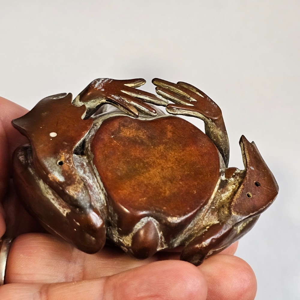 An antique cast bronze frog pen holder featuring textured skin details and inset glass eyes. View XV