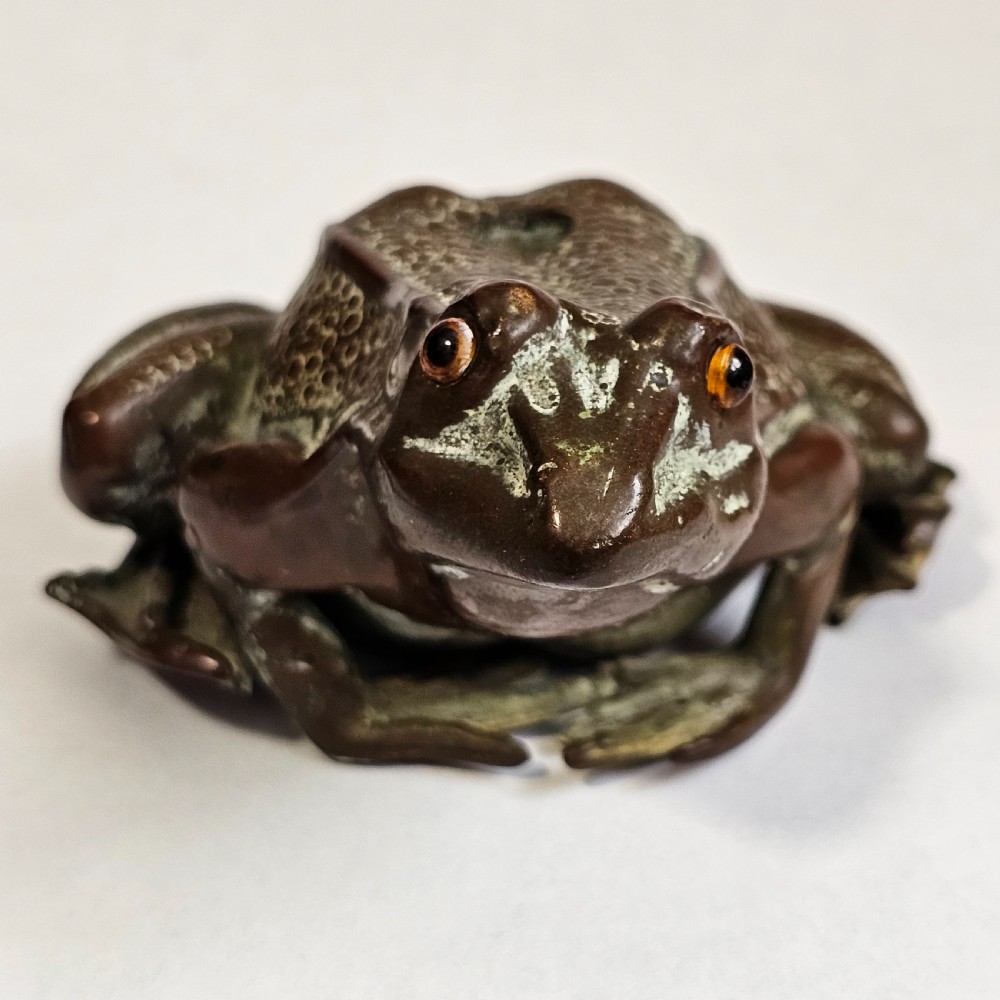 An antique cast bronze frog pen holder featuring textured skin details and inset glass eyes. View XVIII